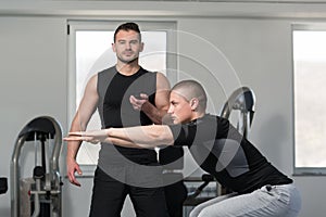 Man With Personal Trainer Train On Bosu Ball