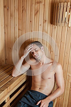Man perspiring inside the sauna