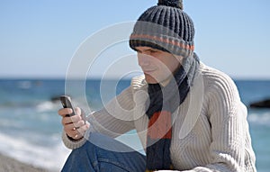 Man with phone on a beach