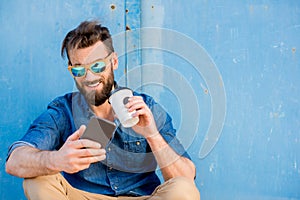 Man with phone on the blue background