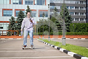 Man with phone and documents rides on GyroScooter photo