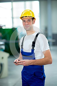 Man with phone in factory