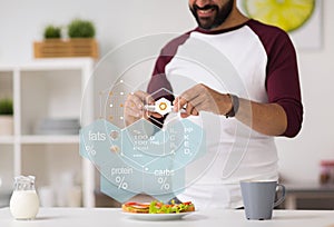 Man with phone and food nutritional value chart