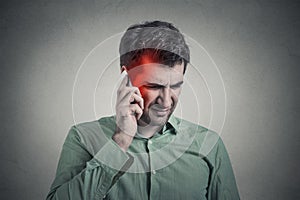 Man on the phone with headache. Cellular mobile radiation concept