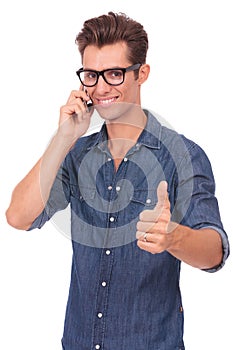 Man on the phone shows thumb up