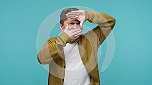 Man photographer looking through photo frame hand gesture, focusing view