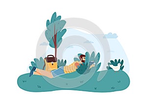Man photographer lying in bushes and taking photo of bird. Male character holding camera and making picture