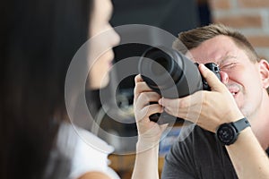 Man photographer is taking pictures of woman closeup