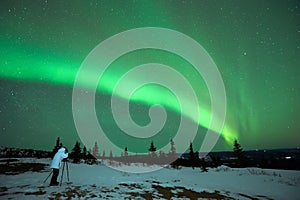 Man photographing the Aurora Borealis