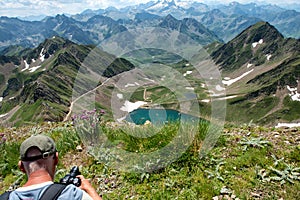 Man photographing the range of Pyrennes mountains