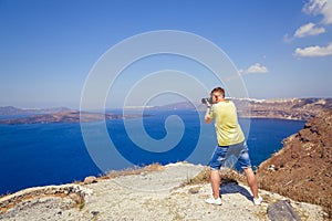 Man photographs the landscape of Santorini