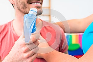 Man taking pulmonary function test with mouthpiece in his hand photo