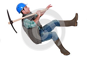 Man with pick-axe falling