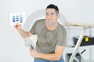 man picking color for house walls