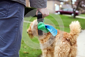 Man Picking up / cleaning up dog droppings. photo