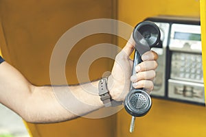 Man picks up the city payphone