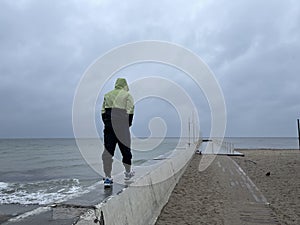 Man on a pier on a rainy day