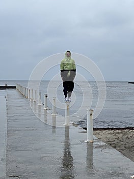 Man on a pier on a rainy day