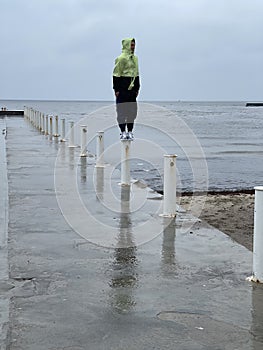 Man on a pier on a rainy day