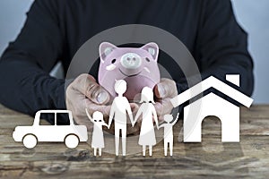 Man with piggy bank, home and car. Concept of saving money for house and car. Saving money concept