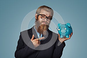 Man with Piggybank With Eyeglasses pointing at it with hand index finger