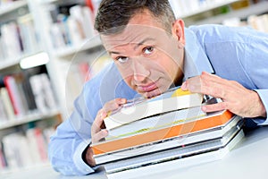 Man with pile books photo