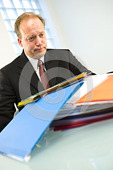 Man with pile of paperwork