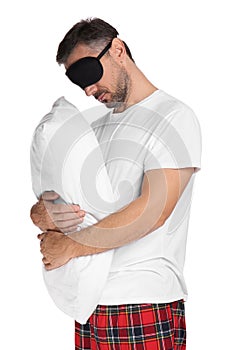 Man with pillow and eye mask in sleepwalking state on white background