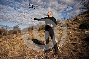 Man piloting drone on the mountain ridge