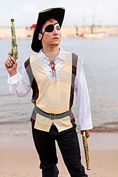 Man in a pirate costume raised to the top toy gun