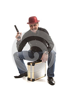 Man with a pistol sitting on the case