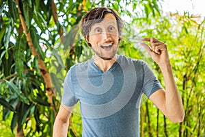 Man placing a bite plate in his mouth to protect his teeth at night from grinding caused by bruxism