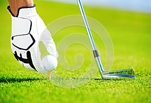 Man Placing Golf Ball on Tee