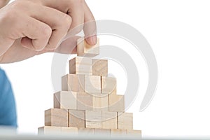 Man placing the last brick on top of the stack