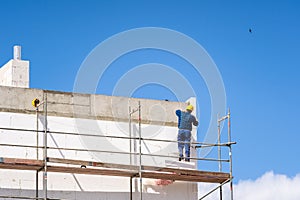 Man placing styrofoam material insulate concrete wall