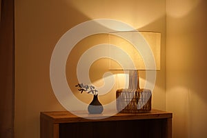 Man placing a table lamp in the corner