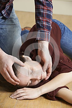 Man Placing Woman In Recovery Position After Accident photo