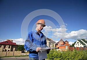 Man with the plan of construction and helmets