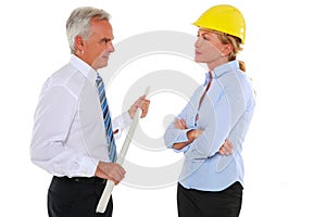 Man with plan and woman architect with hard hat