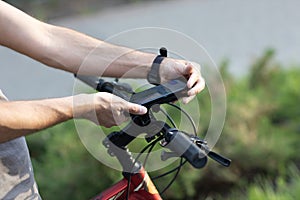 Man planning route using GPS navigation application in mobile phone on his bicycle bike.