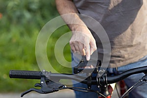 Man planning route using GPS navigation application in mobile phone on his bicycle bike.