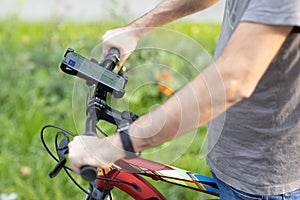 Man planning route using GPS navigation application in mobile phone on his bicycle bike.