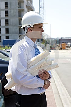Man with plans on construction site