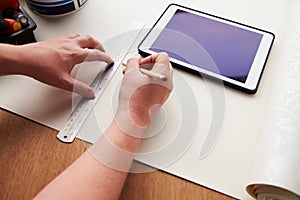 Man Plans Design Project Using Application On Digital Tablet