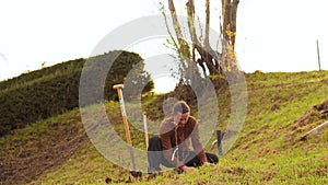 Man plants tree, working in the garden. Nature, environment and ecology concept.