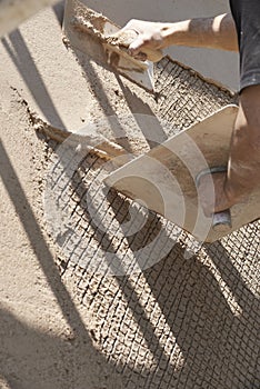 Man plastering wall using trowel