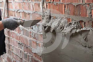 Man plastering wall. Worker makes renovation. Construction work