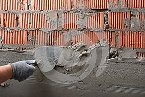 Man plastering wall. Worker makes renovation. Construction work