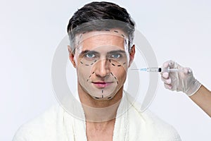 Man at plastic surgery with syringe