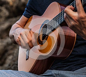 Man play on classic guitar.